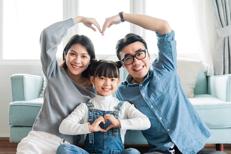 Family making a heart shape with their hands together
